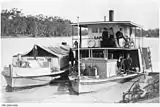 The Paddle Steamer P. S. Sapphire on the Murray River with a barge.