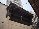 The wooden canopy above the street entrance