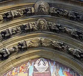 Sculpture in the archivolts depicting the Father, Son and Holy Spirit