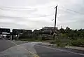 Tioga Street trackage curved to the right and up a ramp to the P&T. The old roadbed ramp is now weed-covered and new curbing and railing blocks the old right of way