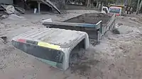 A truck partially submerged in lahar.