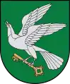 A coat of arms depicting a grey bird with a golden eye and wings outstretched holding a golden key all on a green background