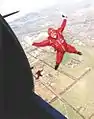 A Red Berets parachute rigger during a jump from a Dakota