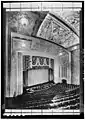 1932 view looking down from the balcony at the ceiling, proscenium, curtain, seating and hydraulic orchestra pit