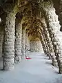 Colonnaded footpath under the roadway viaduct, with external columns sloping to take the diagonal thrust from the vault supporting the road.