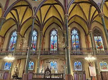 Side of the choir and nave, with 'Stations of the Cross" windows on lower level