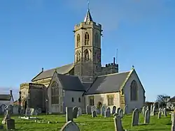 Stone building with octagonal tower topped by a short spirelet