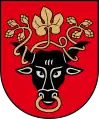 A coat of arms depicting the black head of a bull with a golden vine entangled in its black horns and a golden ring protruding from its nose