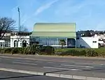 The pavilion; a white building with a green roof