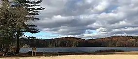 Paugnut State Forest's hills in autumn viewed from the north-east shore of Burr Pond