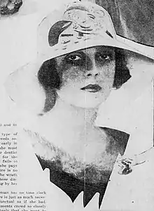 Photograph of Paula Gellibrand, shady headshot with hat in magazine