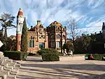 A large building complex of red stone.