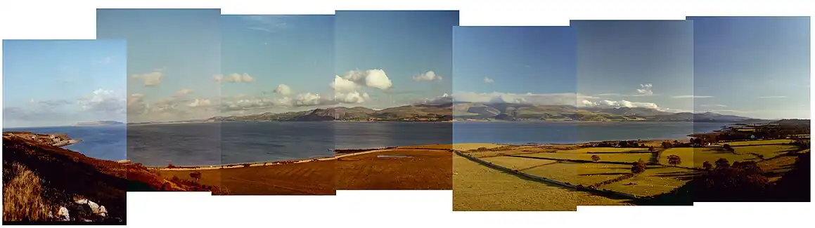 Panorama from Penmon old Deer Park across the Menai Strait  with Snowdonia in the background.