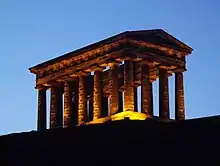 Penshaw Monument lit in yellow at dusk