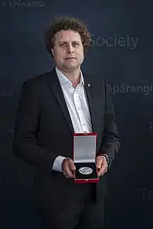 Beck holding a medal box