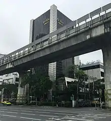 Tall skyscraper behind elevated highway