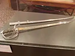 The sword and scabbard which Alexander Oswald Brodie, who served as the Governor of the Territory of Arizona from 1902 to 1905, used during his service with the Rough Riders during the Spanish–American War.  The exhibit is located in the second floor of the Arizona State Capitol Museum.