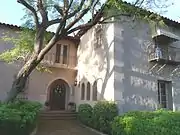 The focal point of the Bennitt Mansion is its arched doorway. The arch is articulated by the use of natural finish concrete formed to replicate cut stone jamb blocks and voussoirs with raked joints. Special craftsmanship is found in the milled door casing, which follows the curve of the semicircular arched opening. The heavy, stained wood door has 11 recessed panel delineated by high-relief moldings. The mansion was listed in the National Register of Historic Places on August 12, 2009, reference #09000609.