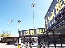 The main entrance of the Phoenix Municipal Stadium. The Phoenix Municipal Stadium was built in 1964 and is located at 5999 E. Van Buren Street in Phoenix. The stadiums’ light poles are the original light poles which were installed in New York's Polo Grounds Stadium in 1940. They served the stadium until 1964, when the stadium was demolished. Horace Stoneham, owner of the San Francisco Giants, whose club started spring training at the previous iteration of the Phoenix Municipal in 1947, had the poles shipped here. The San Francisco Giants played at the ballpark during the spring training of 1964.