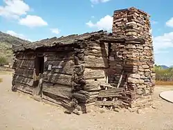 The Flying "V" Cabin was built in 1880 and was located in Canyon Creek, Young, Arizona. The cabin has notched gun ports which were used on July 17, 1882, during the Battle of Big Dry Wash, the last Apache War in that area. John D. Tewksbury Sr., of Pleasant Valley War fame lived here with his two wives and children.