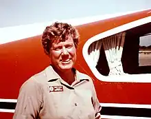 Mary Barr next to her transport plane, 1975