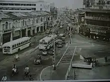 City street with buses, bicyclists and cycle rickshaws