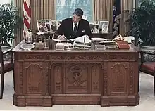  Ronald Reagan workign at the Resolute desk in the Oval Office