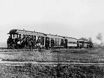 Group photo of passengers on the first train in the city which connected with Urbita Springs