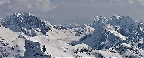 Phantom Peak to left, Mount Crowder to right with McMillan Spires and Mount Terror behind it. View is from Ruth Mountain looking east-southeast.