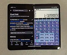 A black foldable smartphone running Wikipedia and another app