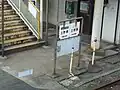 Base of the stairs from forecourt. To the right is the JR station entrance. To the left, the Miniami Aso station.