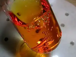 Orange liquid containing bubbles