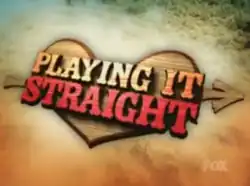 A title card for the American television series Playing It Straight, featuring brown and red letters overlaying a wooden heart that is floating on the ocean shore.