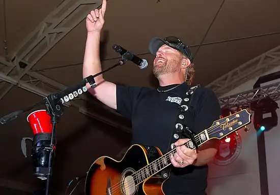 Playing_to_the_base,_Toby_Keith_sings_at_Camp_Buehring_during_his_'Live_In_Overdrive'_USO_tour_120426-A-OQ455-001.jpg