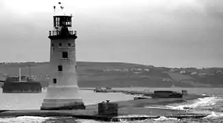 Plymouth breakwater from Kingsand showing the 1844 lighthouse and the Breakwater Fort beyond