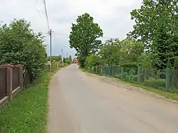 Houses by the unpaved road in Osowicze