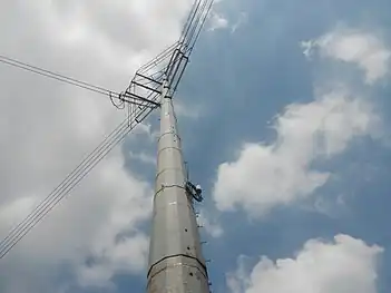 Steel pole 163 located along Magsaysay Boulevard, Manila. Note that the lowest insulator on the left in which it connects to a support steel pole instead of directly connecting to pole 162 like the rest of its insulators.