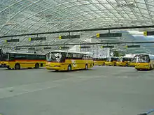 A fleet of Neoplan Transliners in the Swiss "Postautos" colours