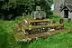 The base of an old cross on a square base with three steps covered in lichen