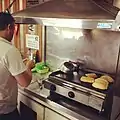 Pão na chapa being prepared on a grill