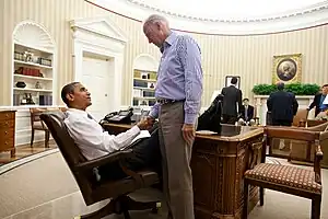 Photo of Obama and Biden shaking hands in the Oval Office