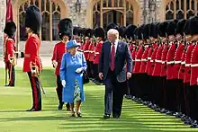 U.S. President Donald Trump and Queen Elizabeth II, accompanied by Major Oliver Biggs, reviewing the 1st Battalion, Coldstream Guards at Windsor Castle during Trump's visit to London in July 2018.