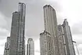 A photo showing most of the neighborhood of Puerto Madero's known highrise, with the El Faro Towers (back right) in the background.