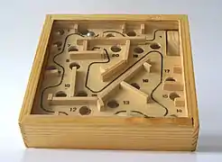 Image 29A ball-in-a-maze puzzle requires fine motor skills. (from Game of skill)