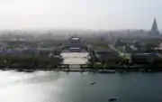 Pyongyang as seen from the Juche Tower, facing west across the Taedong River. The large square in the center is Kim Il Sung Square; the large building behind it is the Grand People's Study House.