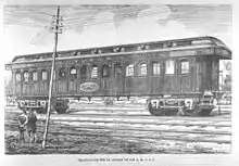 Black and white photo of a railway dining car with the logo of the Q, M, O and OR railway company