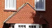 Red brick and tile-hung detail, "a little genuine Queen Anne"