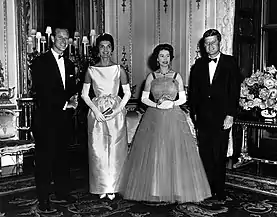 Queen Elizabeth II and Prince Philip, Duke of Edinburgh posing with President John F. Kennedy and First Lady Jacqueline Kennedy during a dinner held at Buckingham Palace for the visiting American delegation, 1961