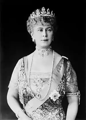 Mary in tiara and gown wearing a choker necklace and a string of diamonds