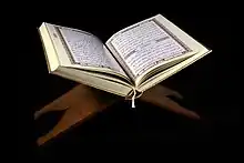 Quran opened, resting on a stand